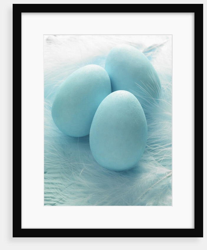 Three blue Easter eggs on feathers by Anonymous