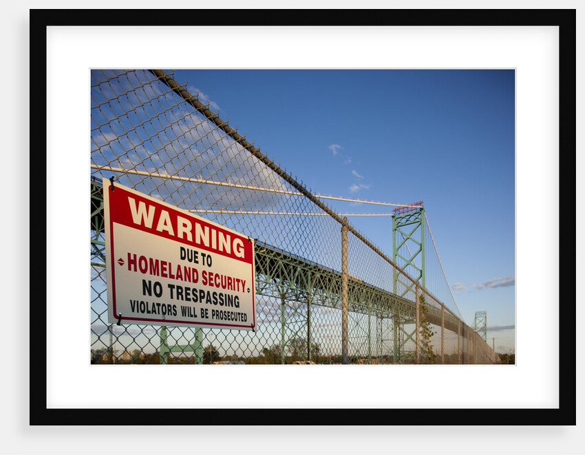 No trespassing sign on fence by the Ambassador Bridge by Anonymous