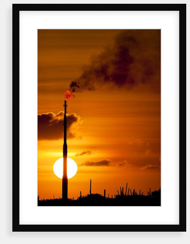 Flames and smoke billow from natural gas flare at Valero Oil Refinery at sunset by Anonymous