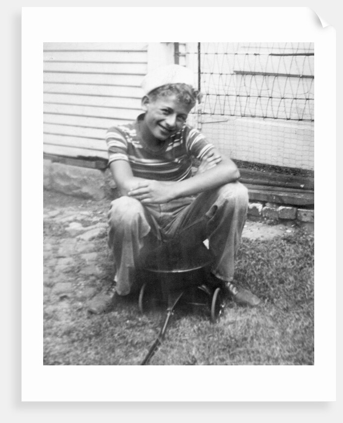 Boy sitting a very small wagon, ca. 1938 by Anonymous