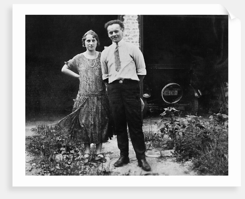 Young couple stands in front of their garage, ca. 1925 by Anonymous