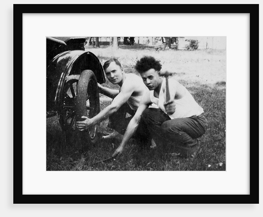 Young men change a tire on an automobile, ca. 1918 by Anonymous