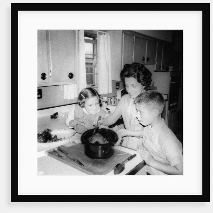 Mom prepares dinner with the kids watching, ca. 1962 by Anonymous