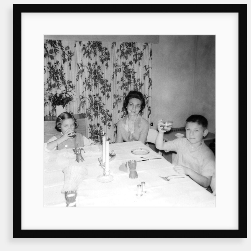 Mother with children at the dinner table, ca. 1962 by Anonymous