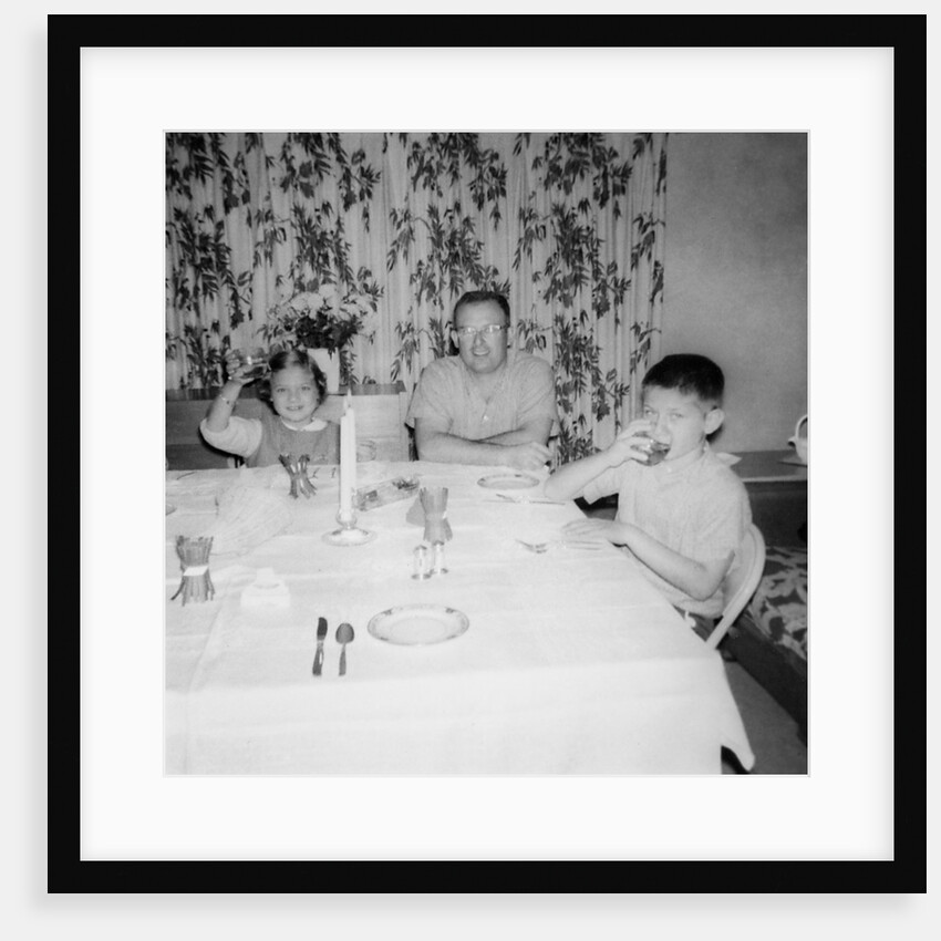 Father with children at the dinner table, ca. 1962 by Anonymous