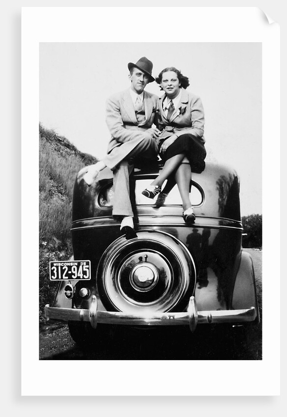 Couple proudly sits on their new car, ca. 1935 by Anonymous