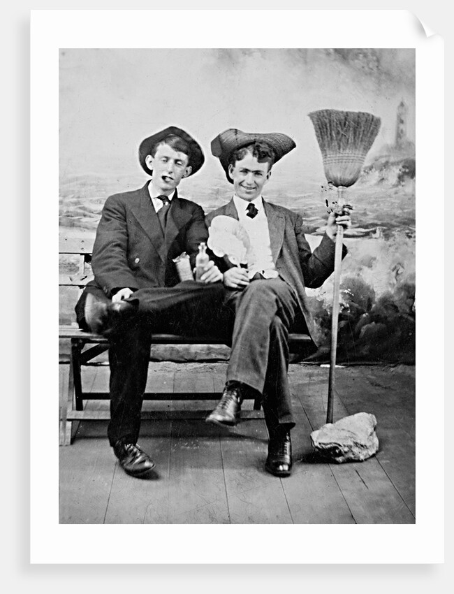Two young men on a bench with a broom, ca. 1900 by Anonymous