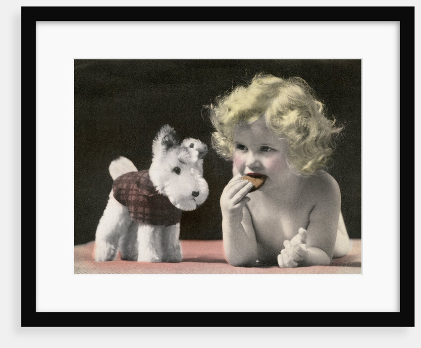 Child eating cookie next to stuffed toy dog by Anonymous