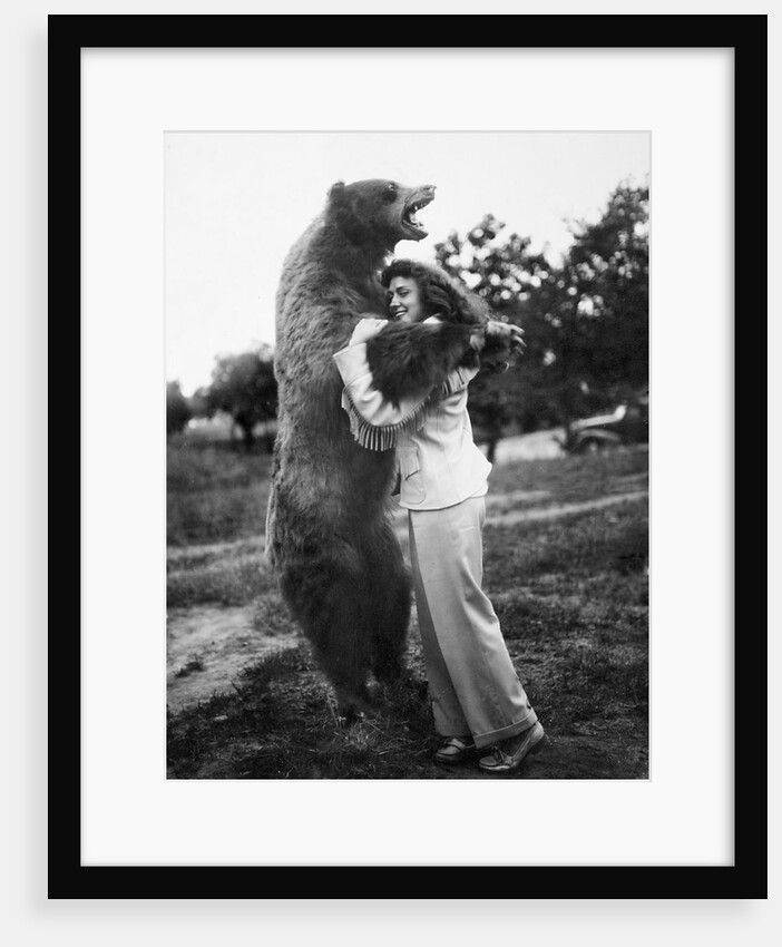 Woman embraces a stuffed bear, ca. 1940 by Anonymous