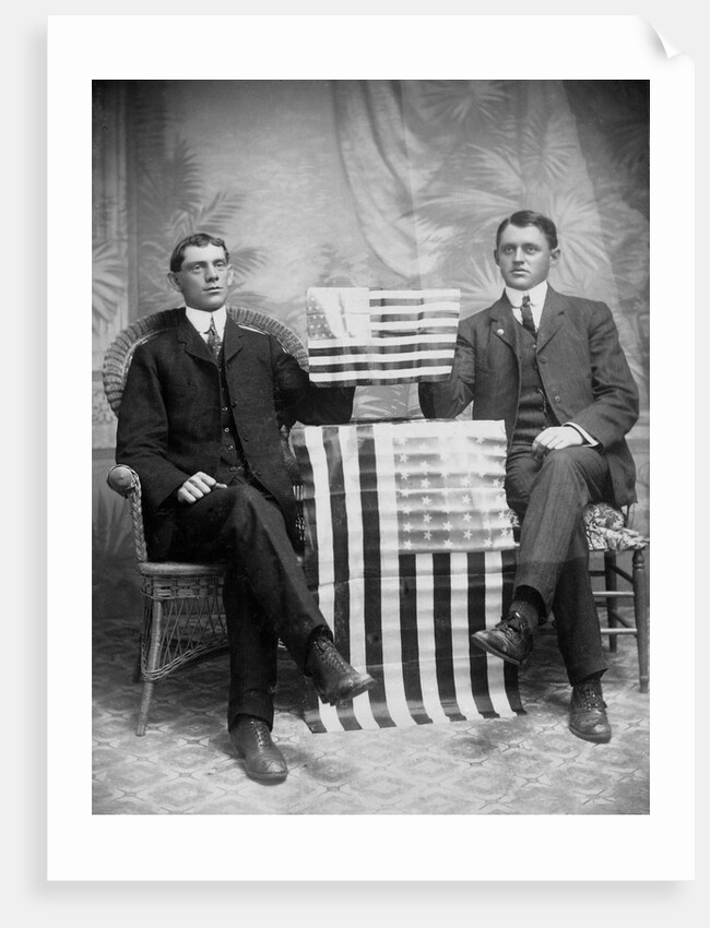 Two men pose with American flags, ca. 1895. by Anonymous