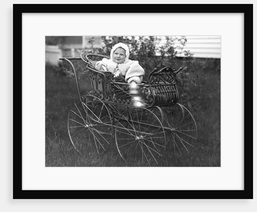Baby in a baby carriage, ca. 1895. by Anonymous