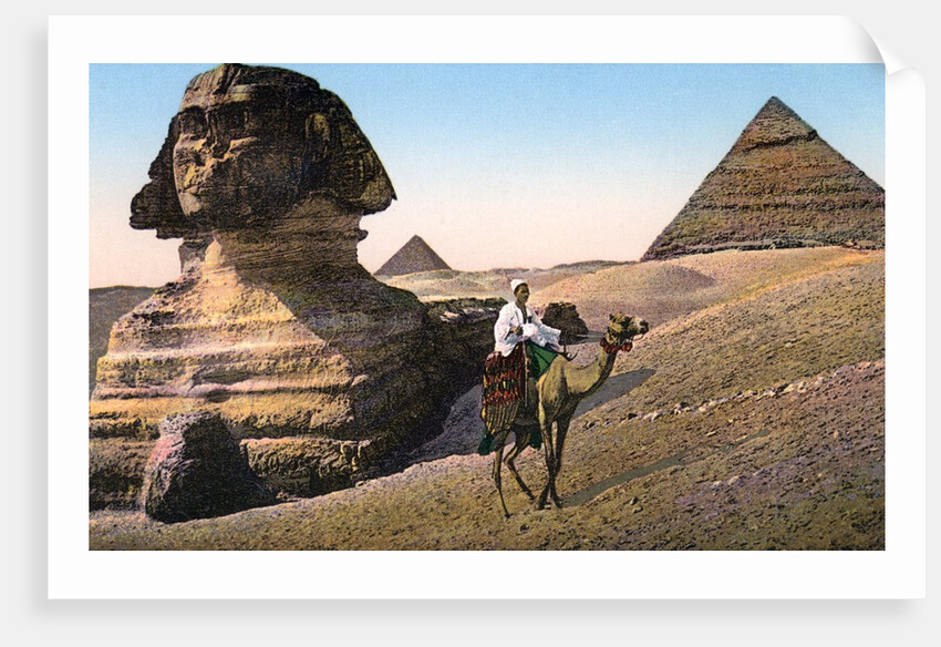 Man riding a camel in front of the Sphinx and pyramids by Anonymous