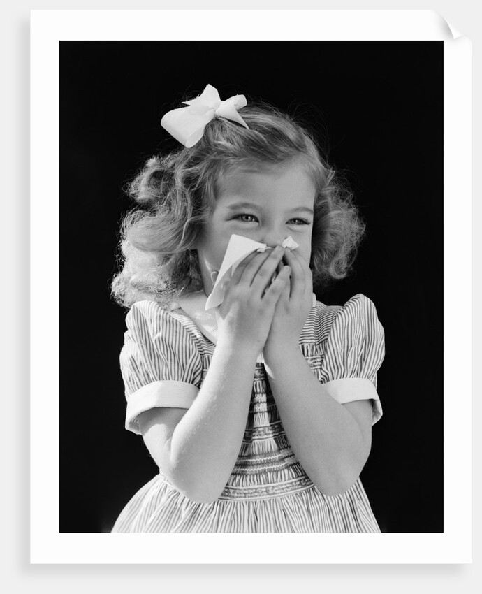 1940s little blond girl ribbon in hair holding tissue to nose sneezing by Anonymous