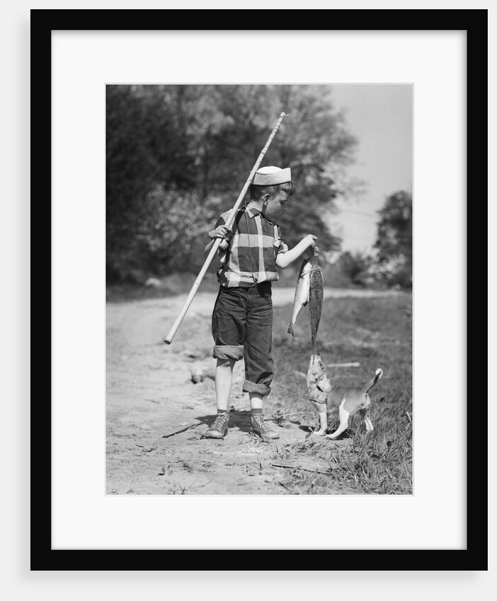 1950s boy plaid shirt sailor hat fishing pole dog pulling on tail of caught fish by Anonymous