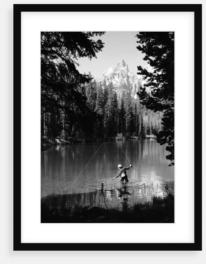 1960s man fishing holding net and rod wyoming grand teton national park string lake by Anonymous