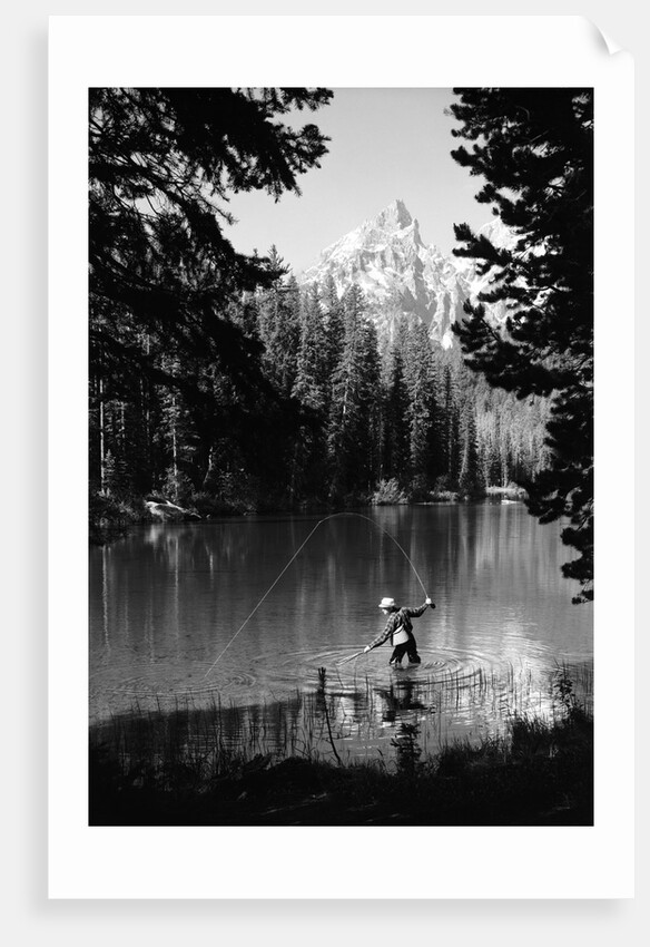 1960s man fishing holding net and rod wyoming grand teton national park string lake by Anonymous