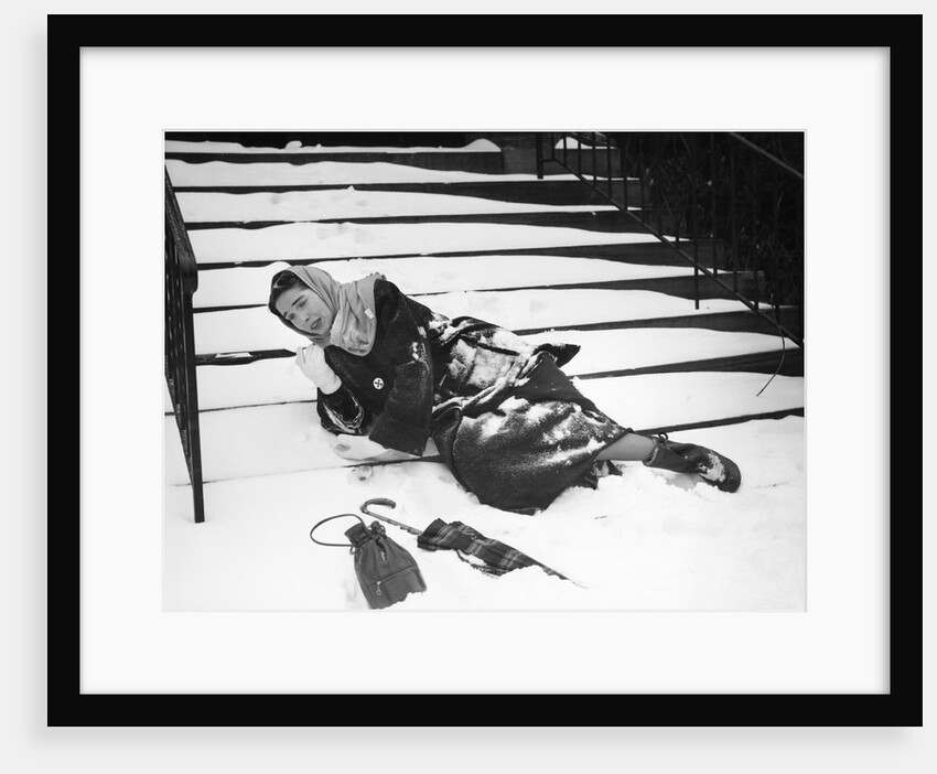 1950s woman lying on snow covered steps fall accident slip expression of pain by Anonymous