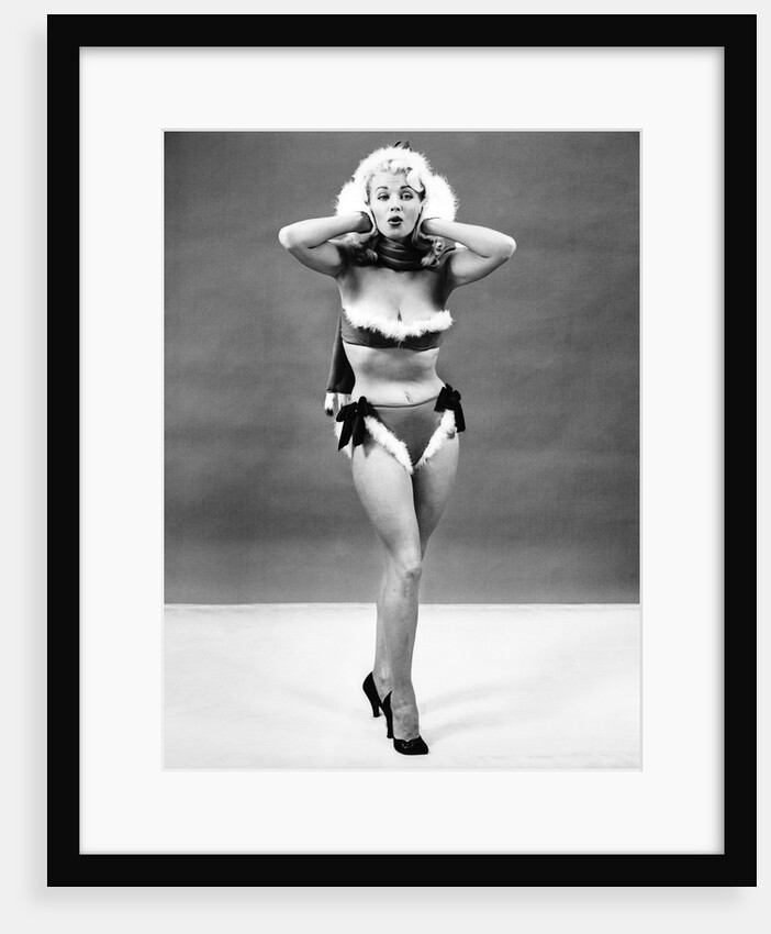 1950s young woman standing inside wearing fur trimmed bikini and gloves by Anonymous