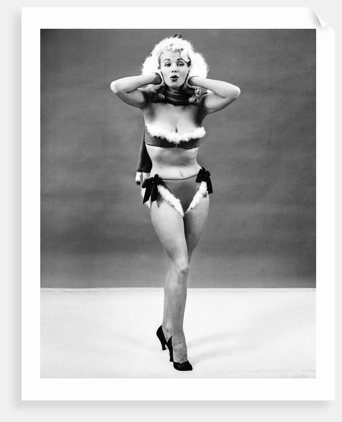 1950s young woman standing inside wearing fur trimmed bikini and gloves by Anonymous