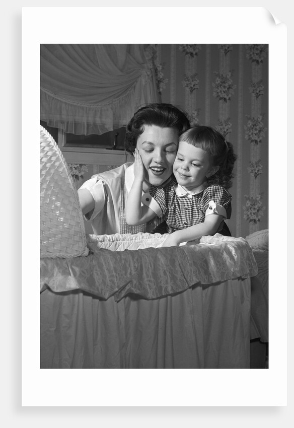 1950s mother & daughter admiring baby in bassinet by Anonymous