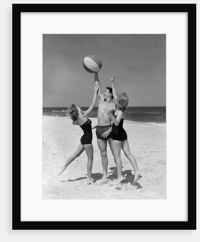 1950s teens jumping for beach ball wearing swim suits by Anonymous