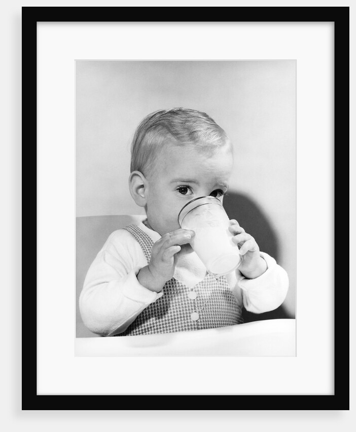 1950s boy toddler drinking glass milk looking at camera by Anonymous