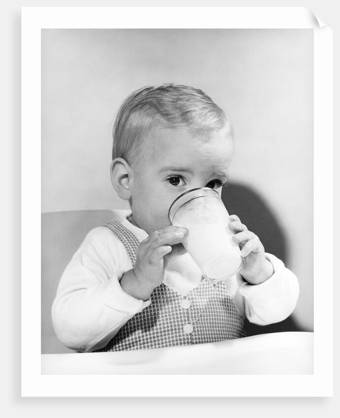 1950s boy toddler drinking glass milk looking at camera by Anonymous
