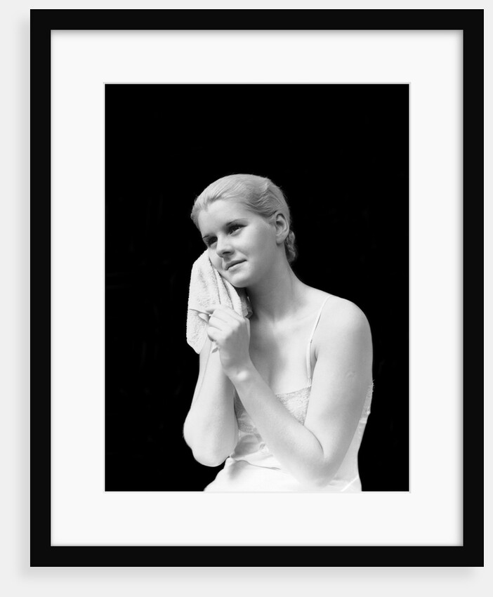 1930s blond woman washing face with washcloth towel by Anonymous
