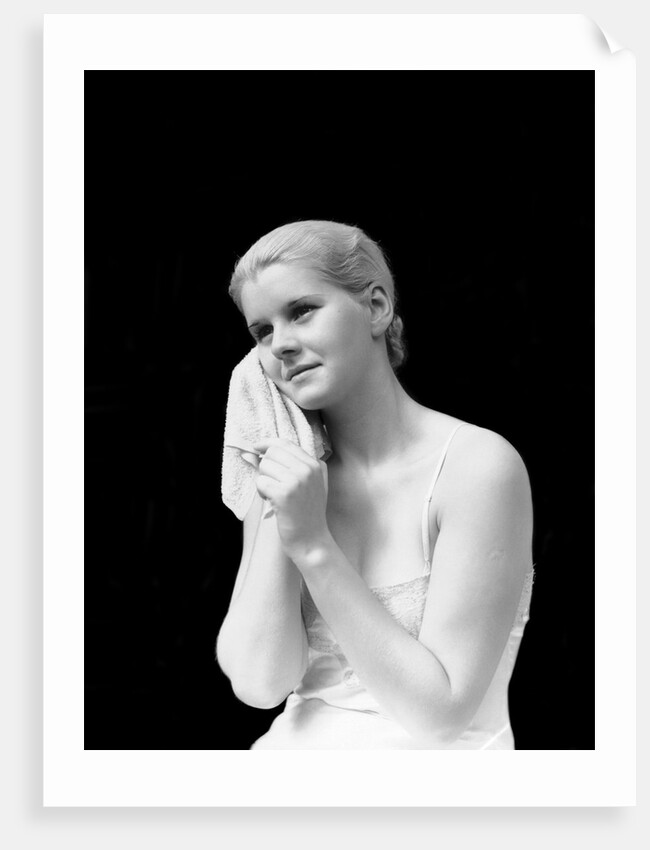 1930s blond woman washing face with washcloth towel by Anonymous