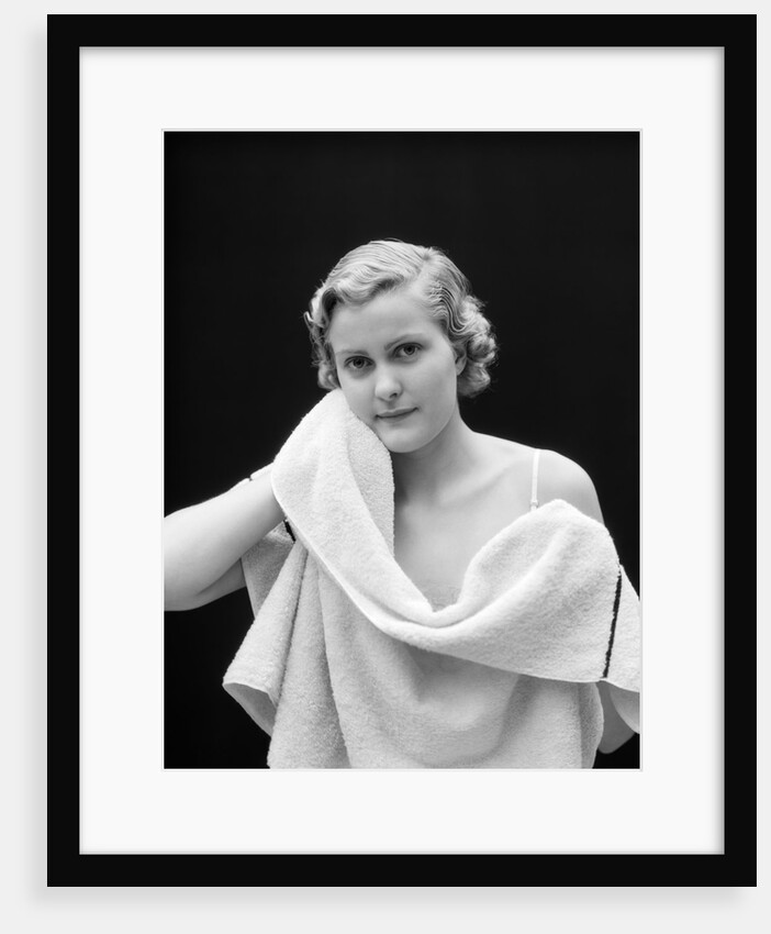 1930s woman drying face with towel looking at camera by Anonymous