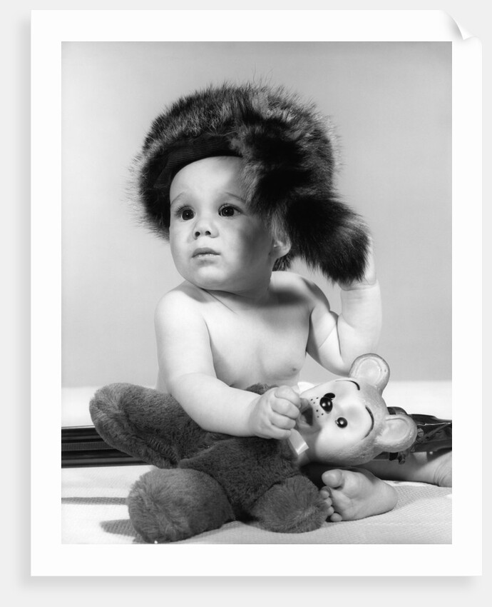 1960s baby wearing coonskin hat by Anonymous