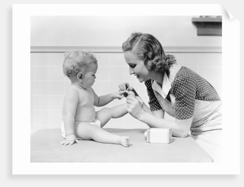 1930s mother touching baby toes fingers this little piggy nursery rhyme by Anonymous