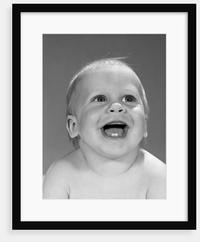 1960s portrait close-up of smiling baby boy showing first two teeth in bottom gums by Anonymous