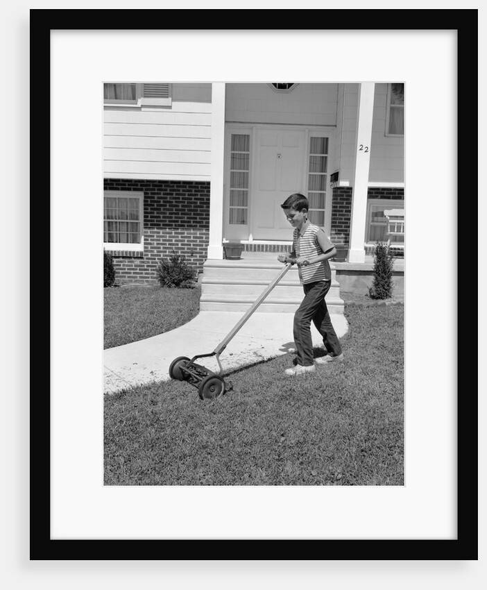 1960s boy cutting mowing suburban home front yard lawn by Anonymous
