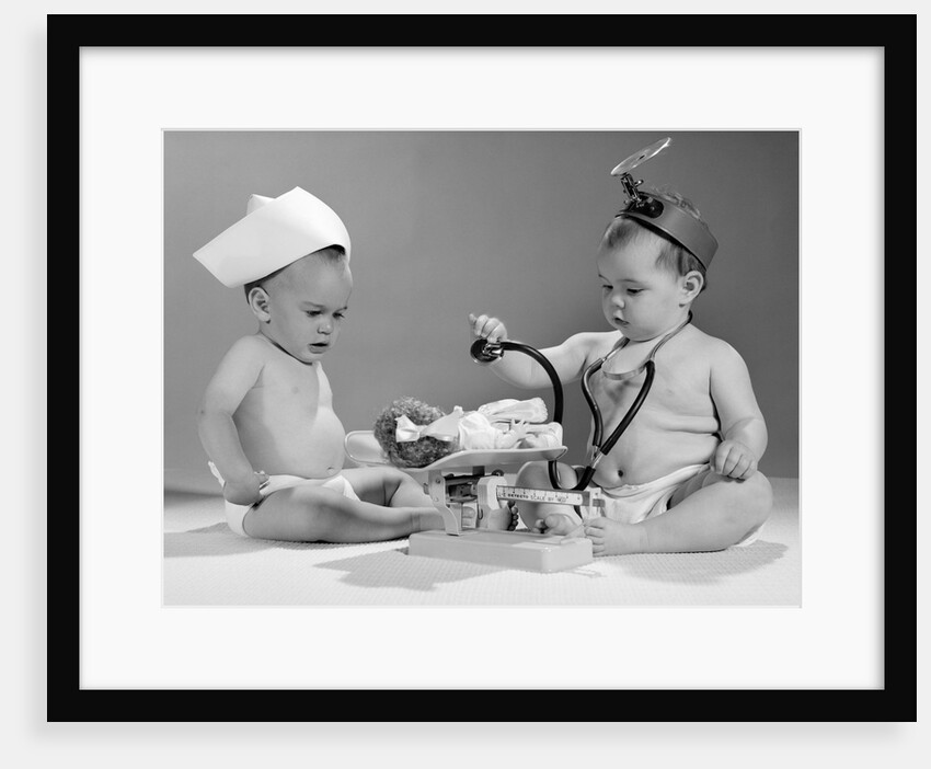 1960s two babies playing doctor and nurse with doll studio by Anonymous