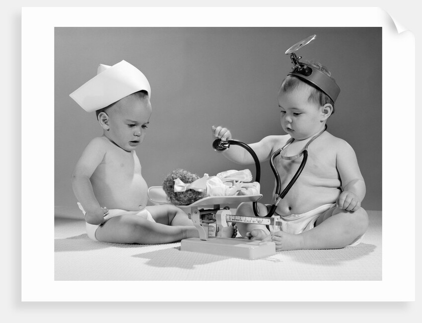 1960s two babies playing doctor and nurse with doll studio by Anonymous