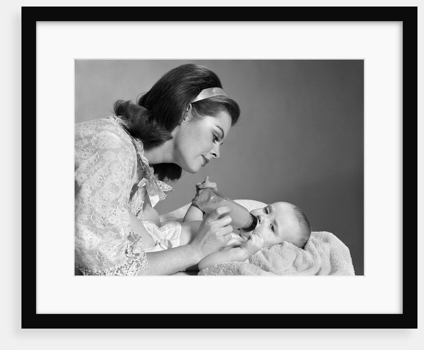 1960s mother bottle feeding infant child by Anonymous