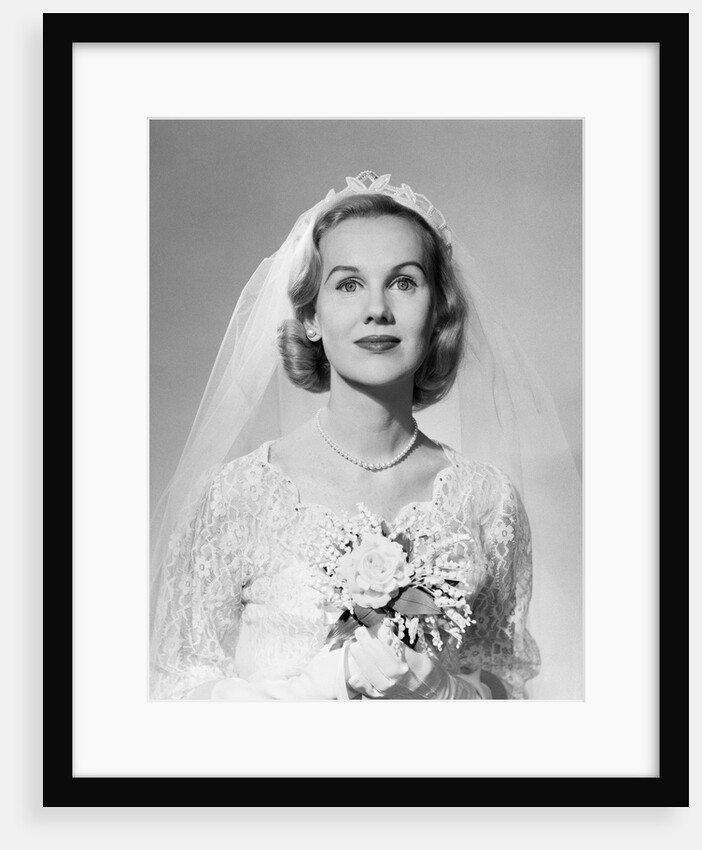 1950s portrait woman bride pearl necklace white gloves holding small bouquet looking at camera by Anonymous