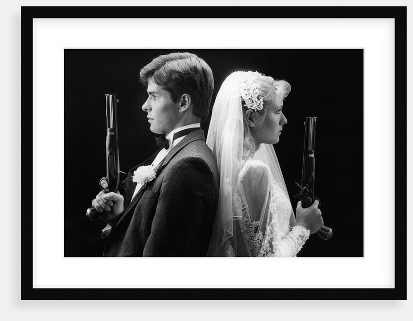1980s bride and groom standing back to back holding dueling pistols by Anonymous