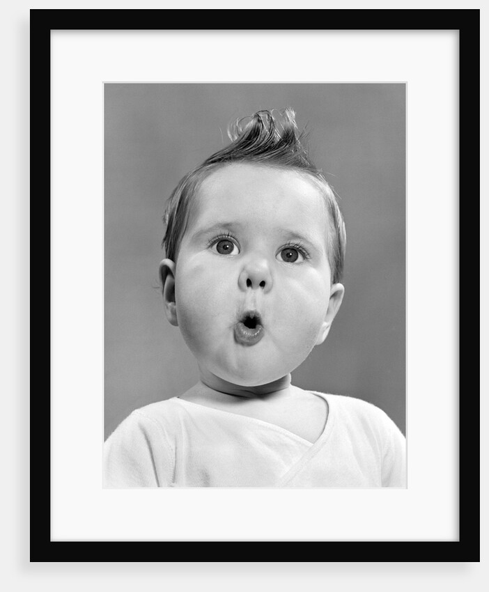 1950s baby with surprised expression by Anonymous