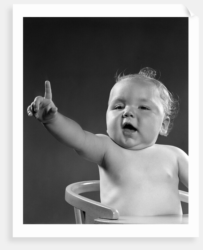 1940s 1950s baby sitting in chair arm and one finger raised objecting voting making a point looking at camera by Anonymous