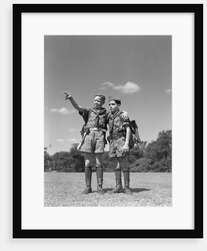 1950s two boy scouts one pointing wearing hiking gear uniforms by Anonymous
