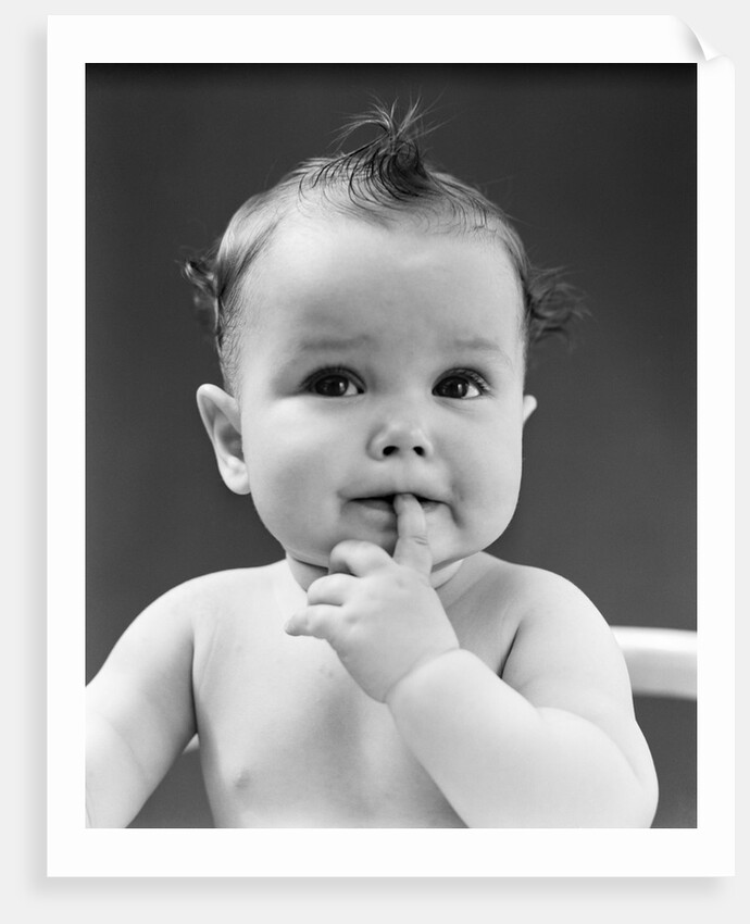 1940s thoughtful baby with finger in mouth by Anonymous