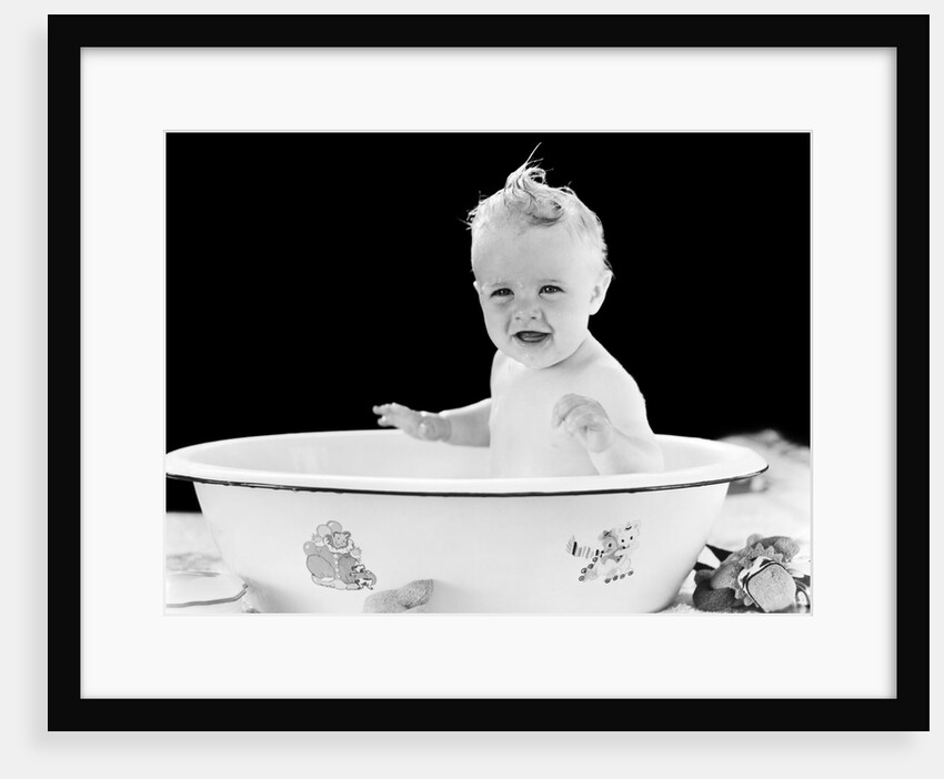 1930s 1940s smiling happy baby sitting in enameled tin bathtub by Anonymous