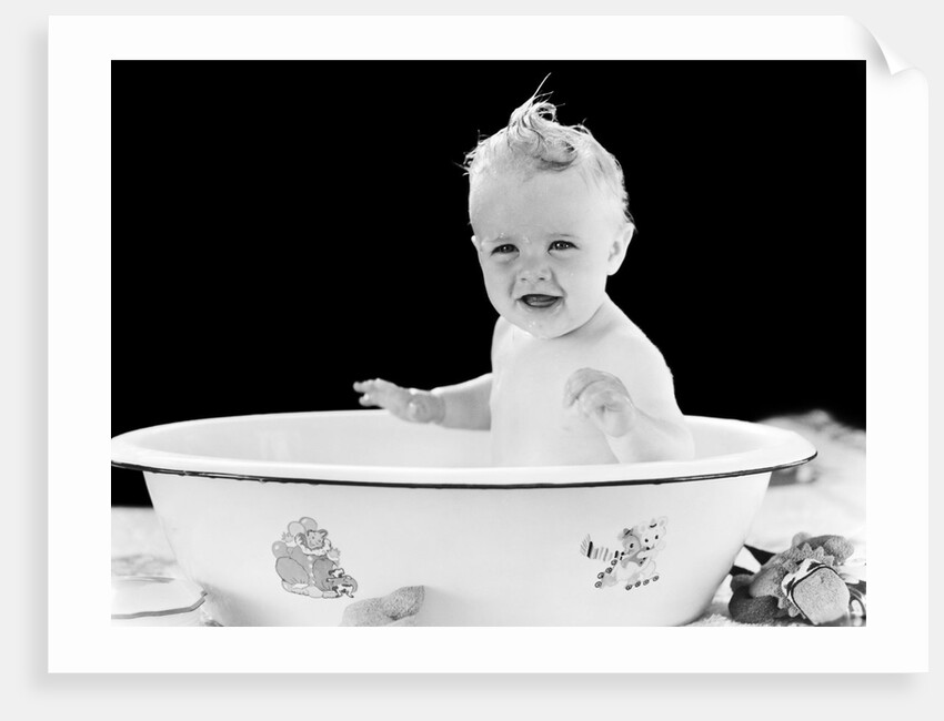 1930s 1940s smiling happy baby sitting in enameled tin bathtub by Anonymous