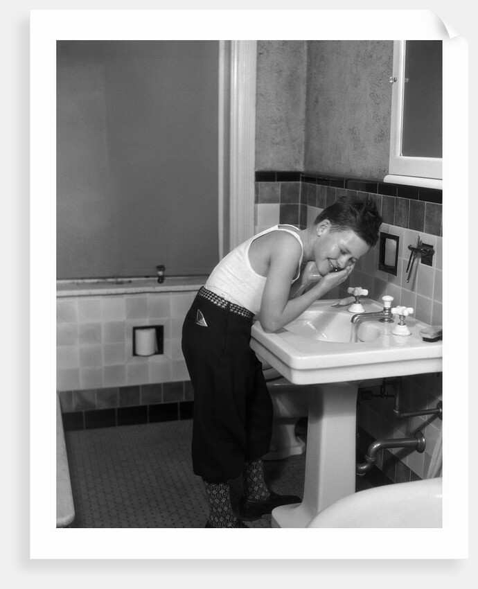 1930s boy washing face at bathroom sink by Anonymous