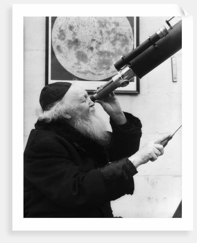 1930s old astronomer white hair and beard wearing skull cap looking through telescope by Anonymous