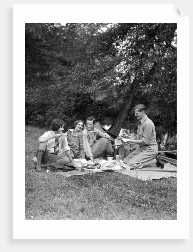 1920s four people two couples men women sitting on ground enjoying a picnic by Anonymous