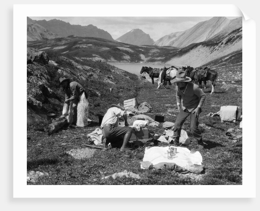 1920s 1930s three men cowboys at campsite preparing food horses in background alberta canada by Anonymous