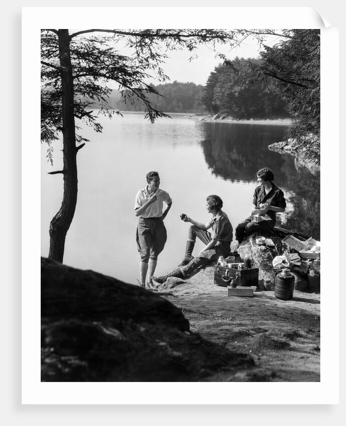 1920s 1930s 3 people picnicking by onata lake man wearing jodhpurs standing two seated women berkshires ma usa by Anonymous